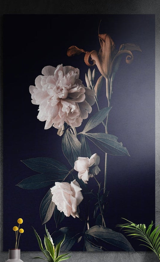 White peony brushed aluminum wall art on a dark gray wall with plants in front of its lower edge
