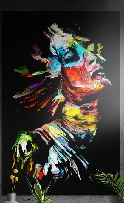 Neon color splash woman face brushed aluminum wall art hung on a dark textured wall above potted plants