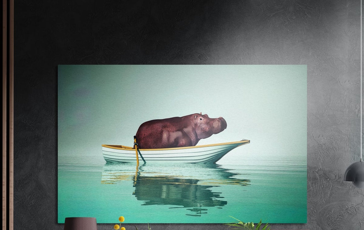 Hippo in a rowboat brushed aluminum wall art on calm teal water, hung on a dark textured wall