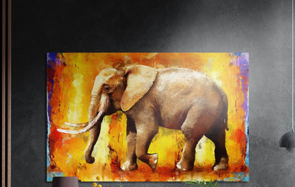 Elephant walking across bright orange brushstrokes brushed aluminum wall art on a dark gray wall above plants