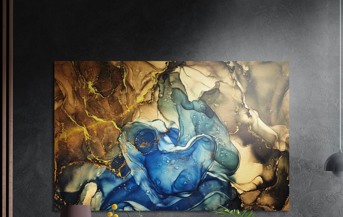 Cobalt blue and amber marble ink brushed aluminum wall art on a dark gray wall above a mauve lamp and plants
