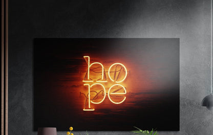 Warm orange neon hope lettering on dark wood, brushed aluminum wall art on a dark gray wall above a sideboard