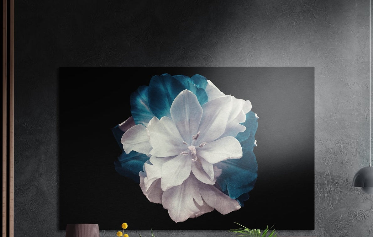 White and teal bloom brushed aluminum wall art on a dark textured wall beside a gray pendant lamp