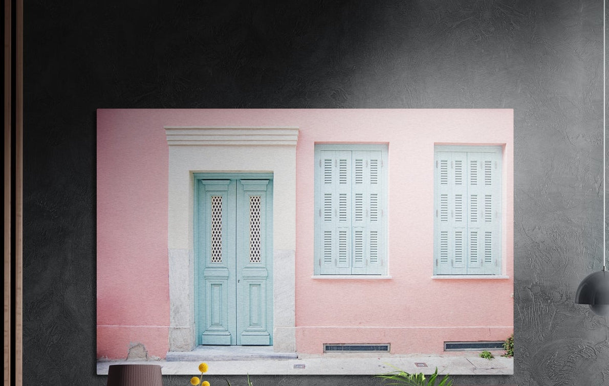 Pink house with turquoise door brushed aluminum wall art on a dark gray concrete wall