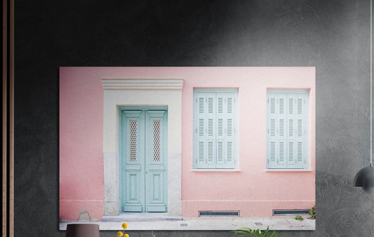 Pink house with turquoise door brushed aluminum wall art on a dark gray concrete wall