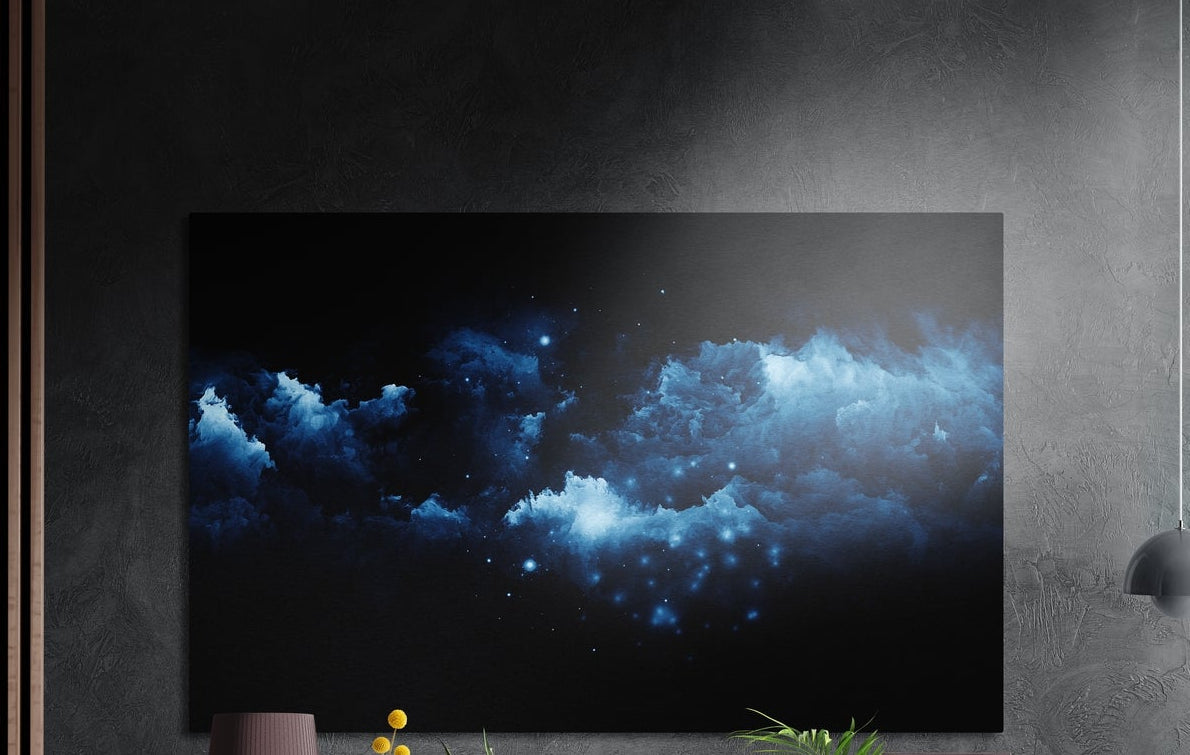 Blue nebula clouds in deep space brushed aluminum wall art on a gray concrete wall with a lamp and plants below