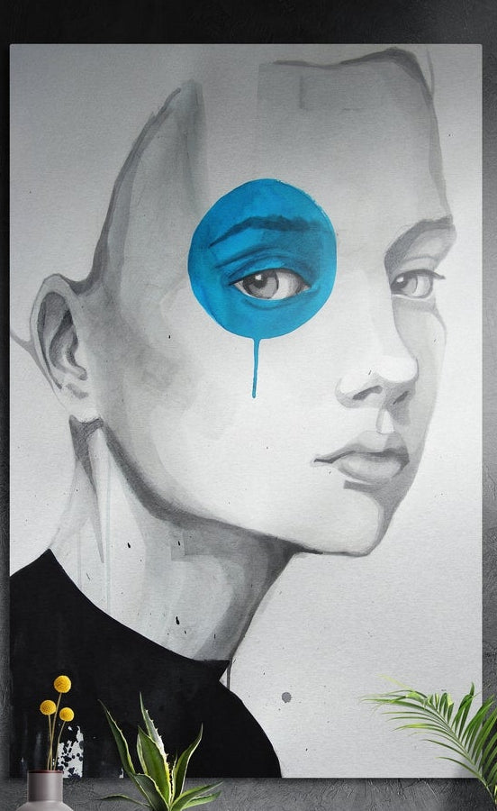 Pencil sketch of a woman with a blue paint blot over one eye, brushed aluminum wall art on a dark wall above plants
