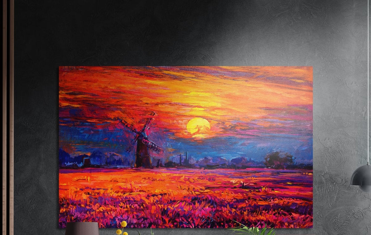 Windmill sunset brushed aluminum wall art on a dark gray wall above a sideboard with a vase and plants