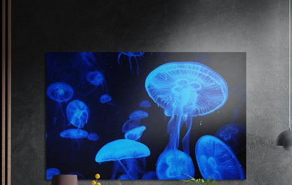 Glowing blue jellyfish brushed aluminum wall art on a dark textured wall above a lamp and plants