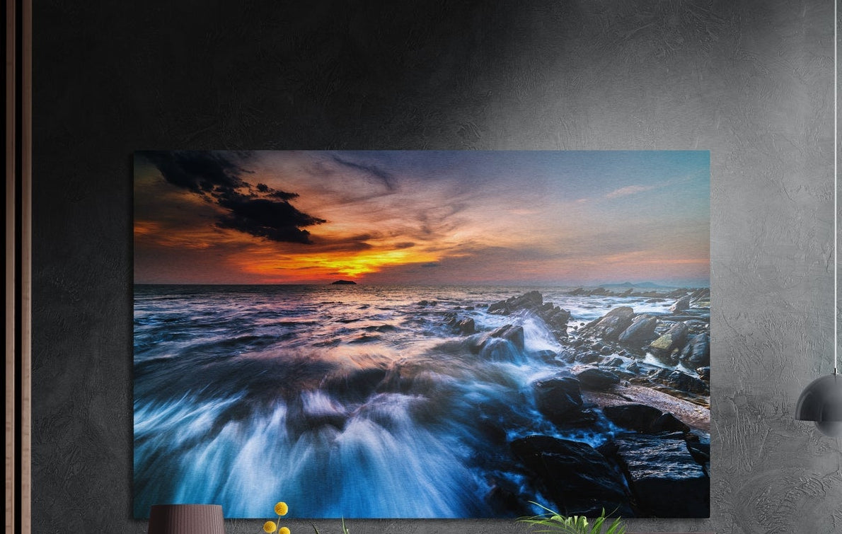 Rocky shore sunset waves brushed aluminum wall art on a dark textured wall