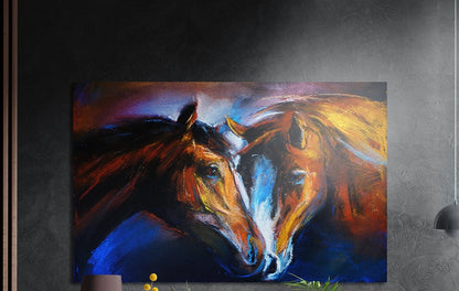 Two chestnut horses touching noses in orange and gold strokes on deep blue, brushed aluminum wall art on a dark wall