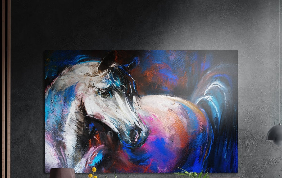 White horse in loose blue, pink and violet brushstrokes, brushed aluminum wall art on a gray wall above a vase