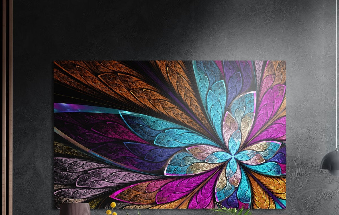 Jewel tone fractal flower brushed aluminum wall art on a dark gray wall beside a black wall lamp