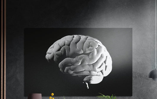 White halftone brain on a black background, brushed aluminum wall art on a dark gray wall above a sideboard