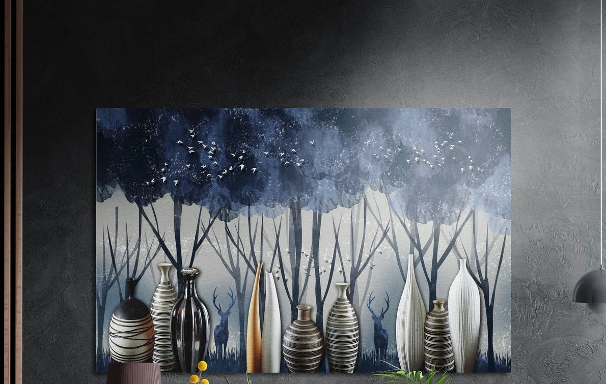 Striped black and white vases with deer in a misty blue forest brushed aluminum wall art on a dark wall above a lamp