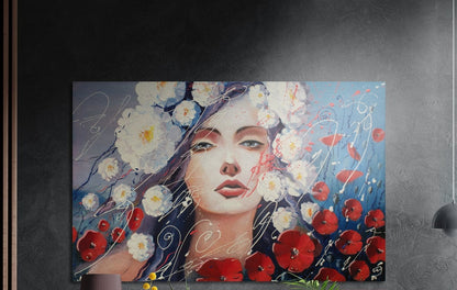 Woman with red poppies and white blossoms brushed aluminum wall art on a dark wall above a lamp and yellow flowers