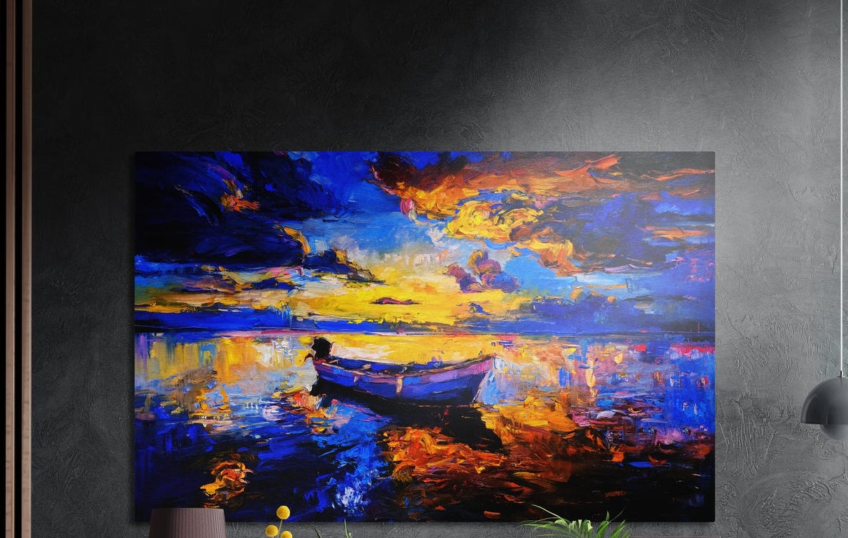 Blue and gold lake sunset brushed aluminum wall art on a dark gray wall above a sideboard with a vase and plants