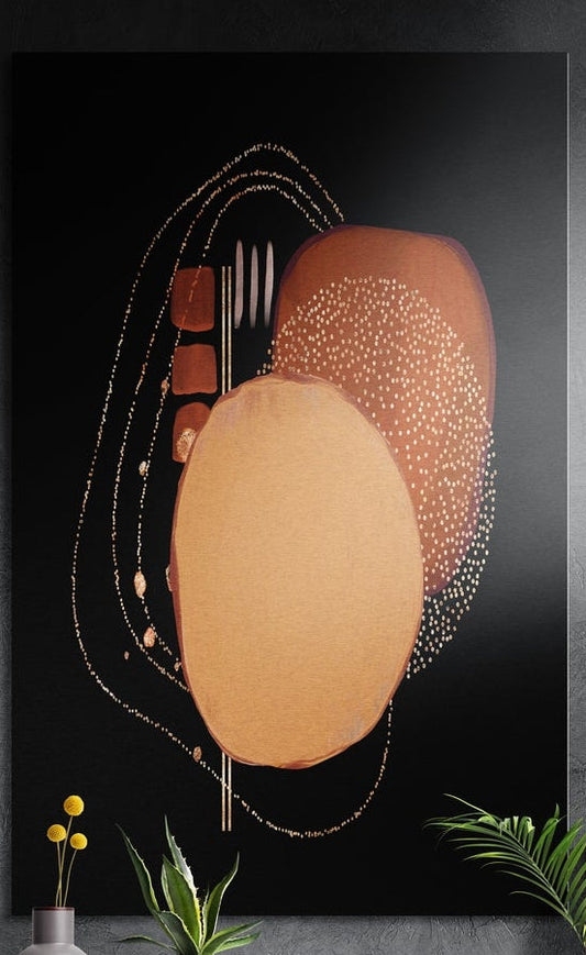 Copper ovals with gold dots on black brushed aluminum wall art on a dark wall behind yellow flowers and green plants