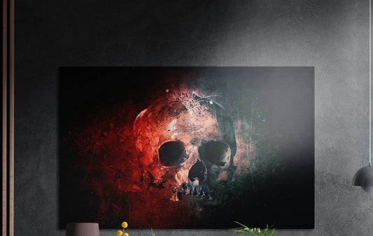 Red and teal grunge skull brushed aluminum wall art on a gray concrete wall with a lamp and plants below