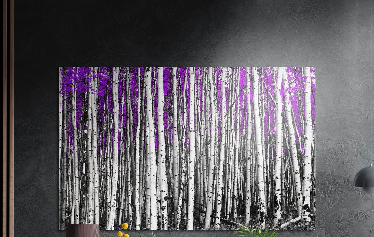 Purple birch forest brushed aluminum wall art on a dark gray wall above a sideboard with a vase and plants