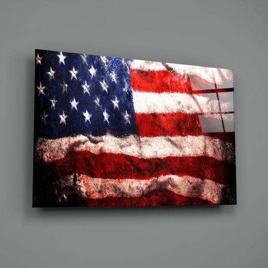 Distressed waving American flag glass wall art on a gray wall, light catching the glossy glass surface