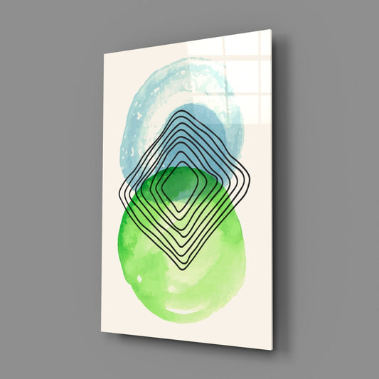 Blue green watercolor circles glass wall art on a gray wall with soft window light