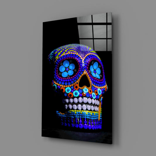 Cobalt blue dotted sugar skull glass wall art on a gray wall with a glossy reflection