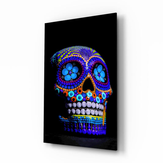 Cobalt blue dotted sugar skull glass wall art on a white background, tall piece shown at an angle