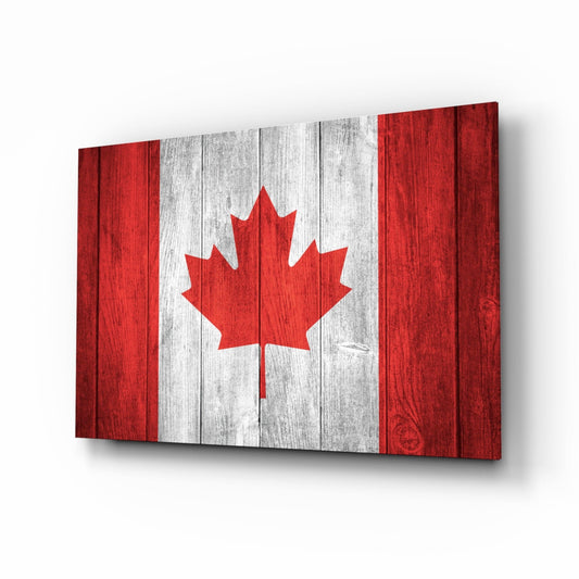 Canada flag on weathered wood planks, red maple leaf on a white center with red side bands, on glass