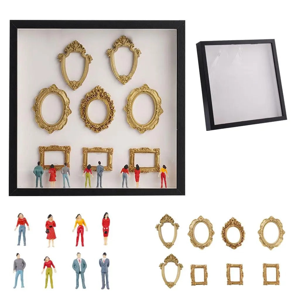 Set of miniature museum and small figures in front of a black frame with white mat.