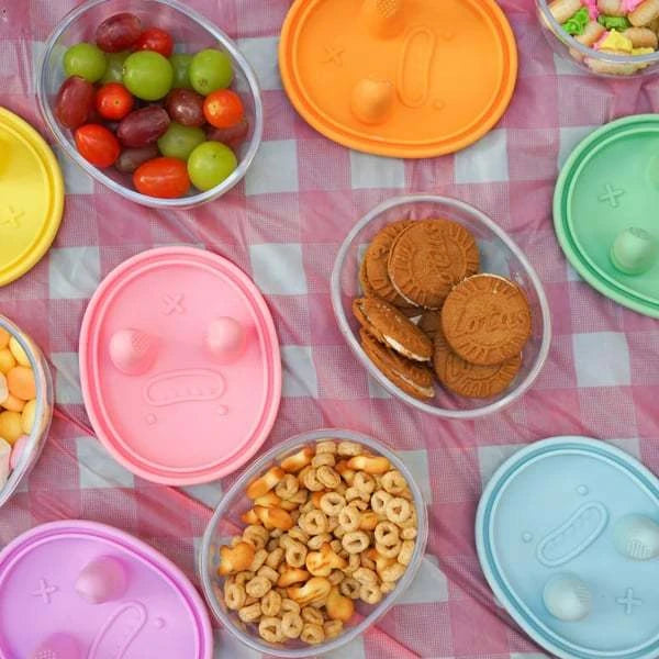 cute snack box with dispenser button at picnic