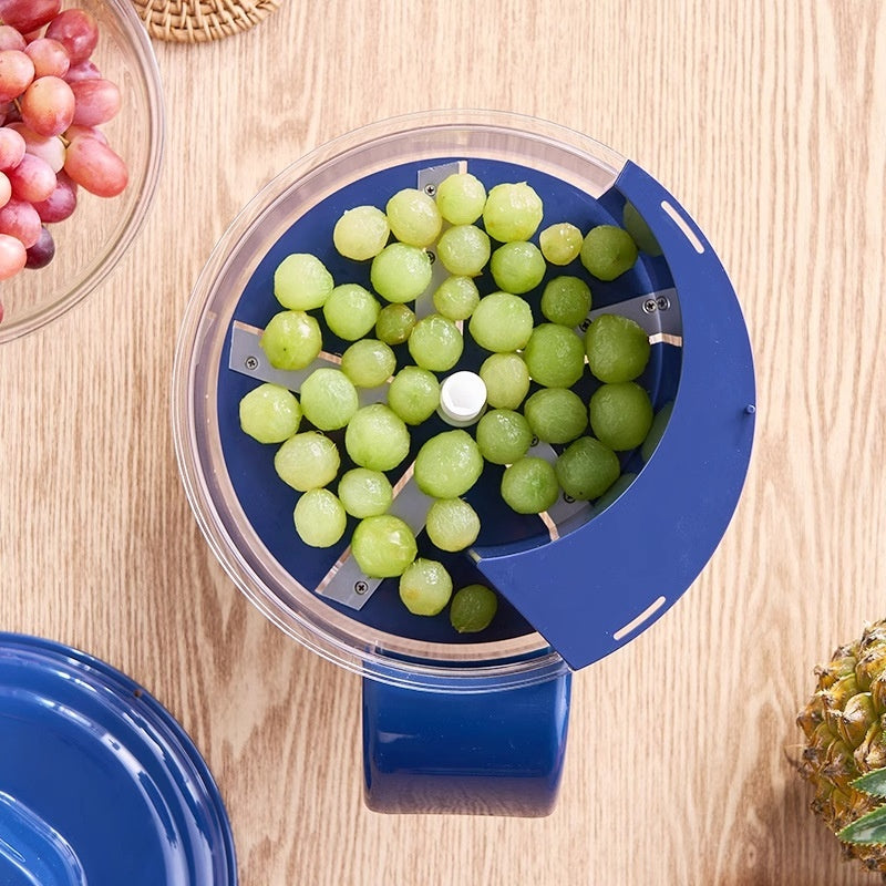 Blue grape squeezer with green peeled grapes on a wooden surface