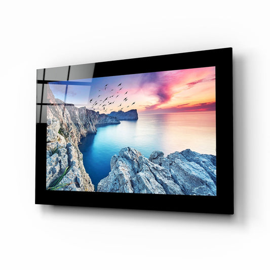 Birds and reefs coastal glass wall art - cliffside bird flock at scarlet sunset over cobalt cove