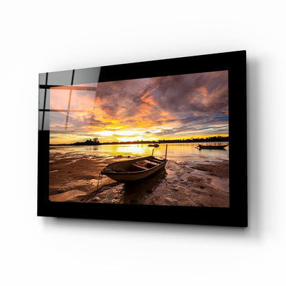 Stranded rowboat sunset glass wall art in scarlet and amber