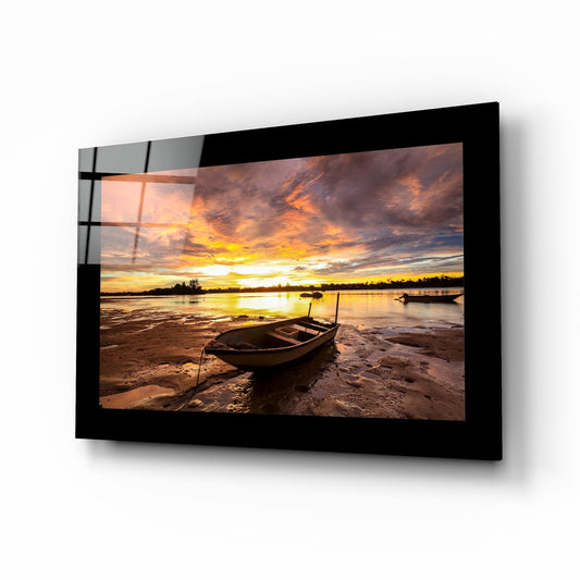 Stranded rowboat sunset glass wall art in scarlet and amber