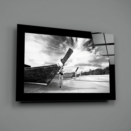 Longtail boat glass wall art shown at an angle against a gray wall