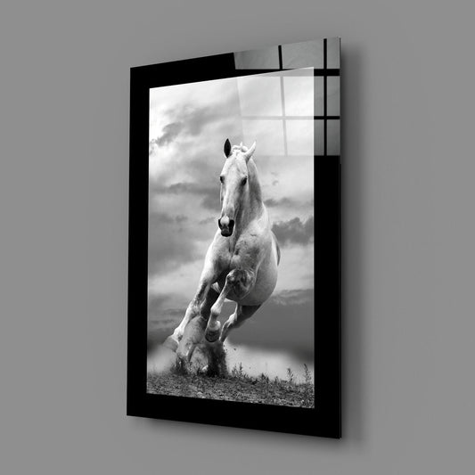 Galloping white horse glass wall art on a gray wall, a window reflected in its glossy front