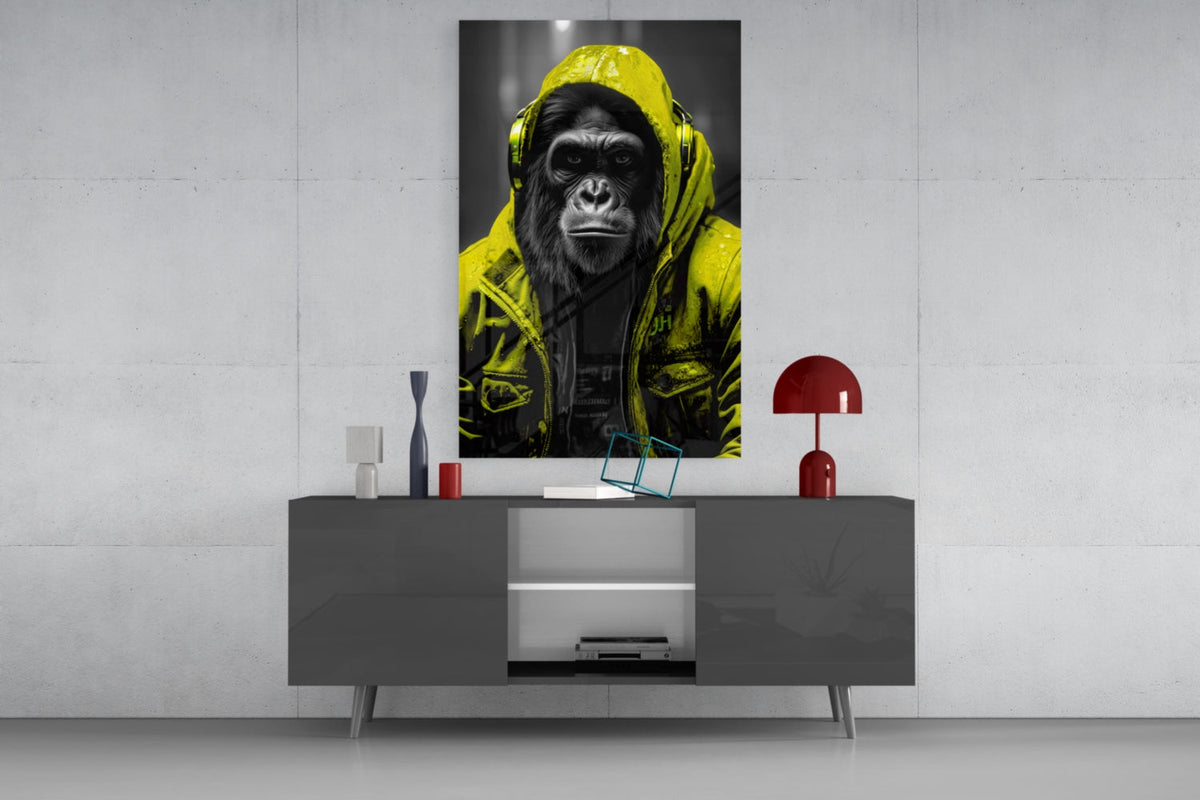 Yellow rain hood gorilla glass wall art on a concrete wall above a gray sideboard with small decor