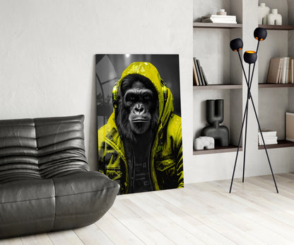 Yellow rain hood gorilla glass wall art leaning beside a black leather lounge chair and shelves