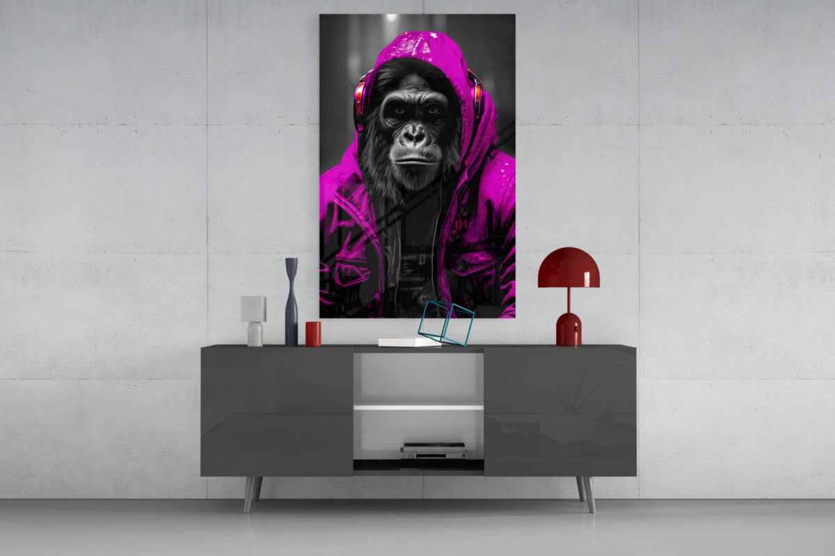 Pink rain hood gorilla glass wall art on a concrete wall above a gray sideboard with small decor
