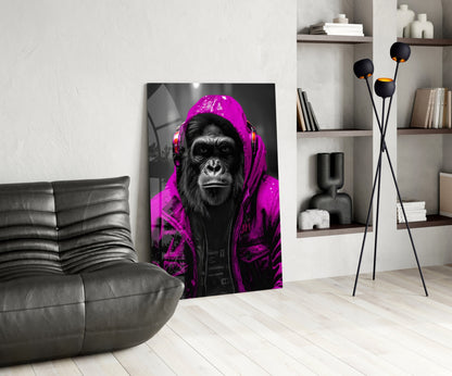Pink rain hood gorilla glass wall art leaning beside a black leather lounge chair and shelves
