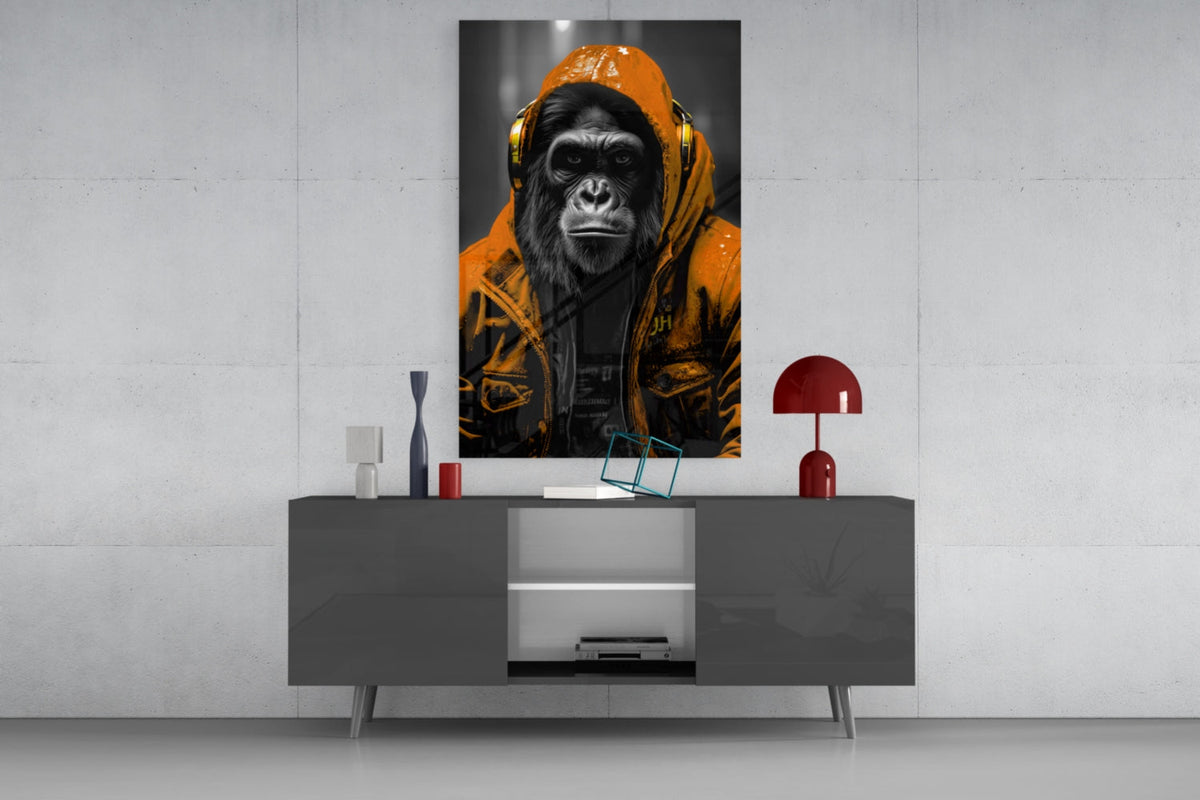 Orange rain hood gorilla glass wall art on a concrete wall above a gray sideboard with small decor