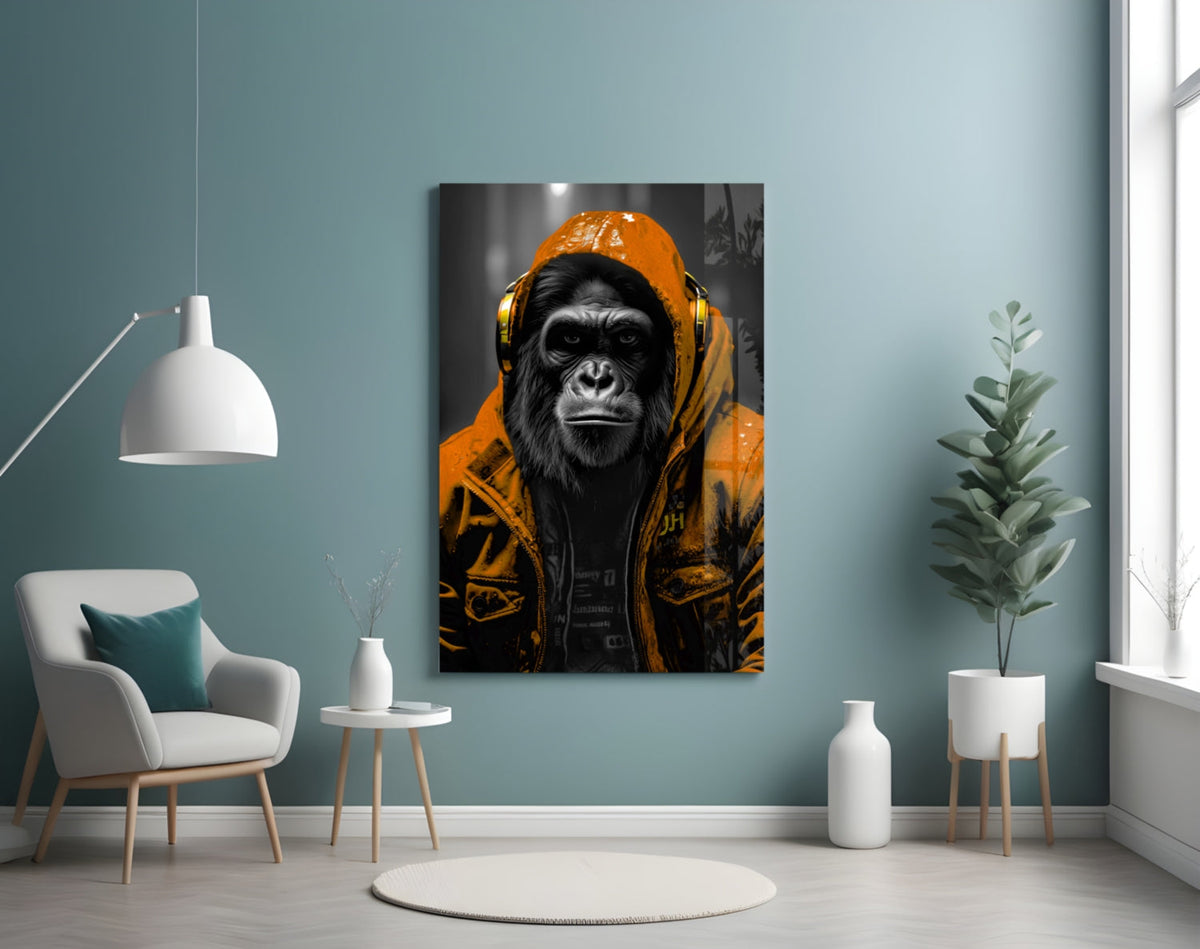 Orange rain hood gorilla glass wall art on a blue-gray wall beside a white armchair and plant
