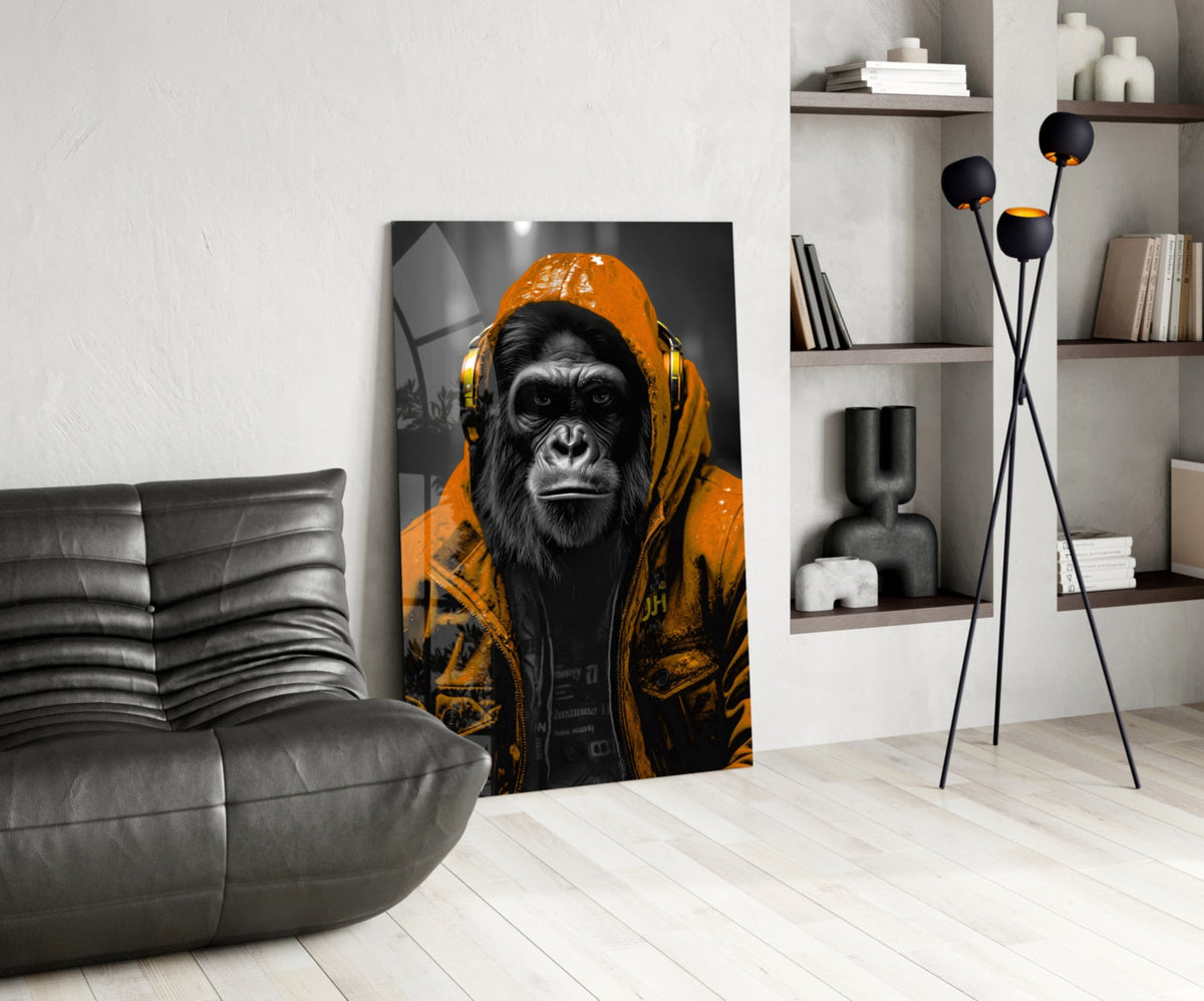 Orange rain hood gorilla glass wall art leaning beside a black leather lounge chair and shelves