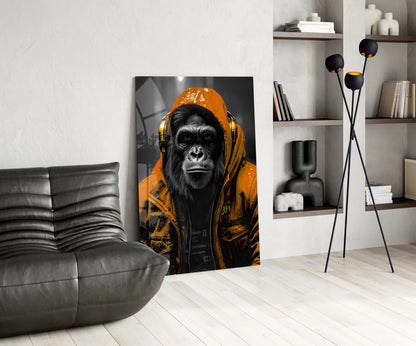 Orange rain hood gorilla glass wall art leaning beside a black leather lounge chair and shelves
