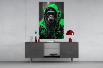 Green rain hood gorilla glass wall art on a concrete wall above a gray sideboard with small decor