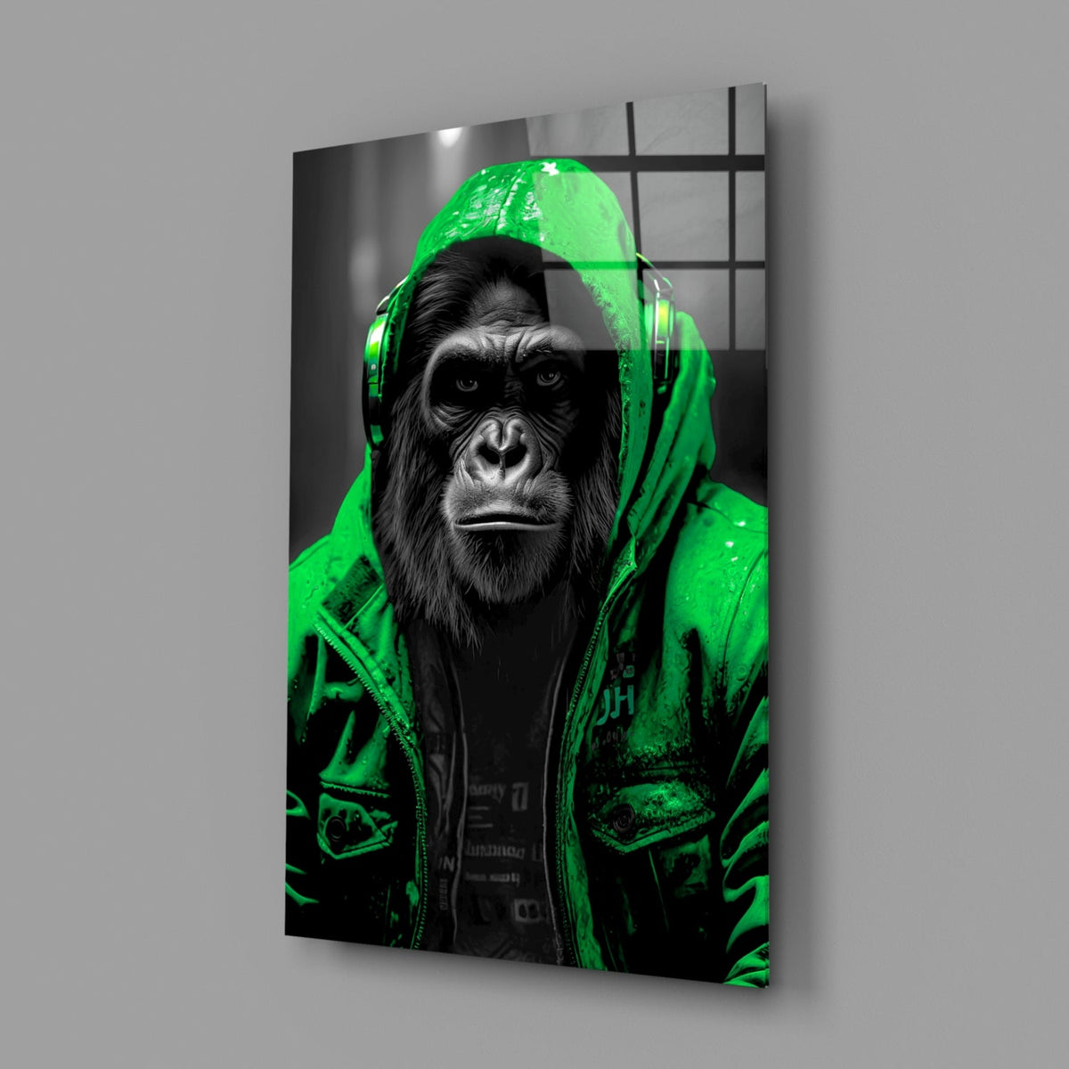 Green rain hood gorilla glass wall art on a gray wall with a soft window reflection