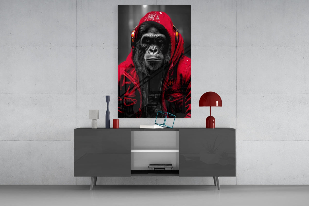 Red rain hood gorilla glass wall art on a concrete wall above a gray sideboard with small decor