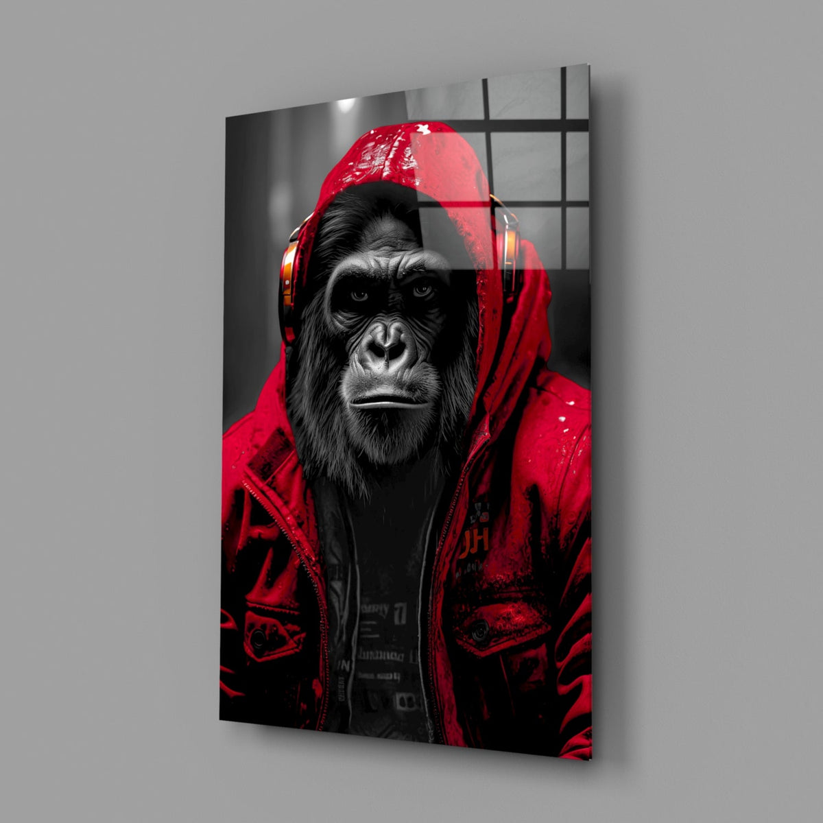 Red rain hood gorilla glass wall art on a gray wall with a soft window reflection