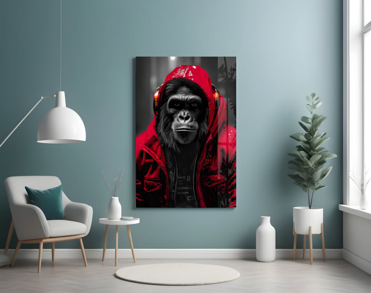 Red rain hood gorilla glass wall art on a blue-gray wall beside a white armchair and plant